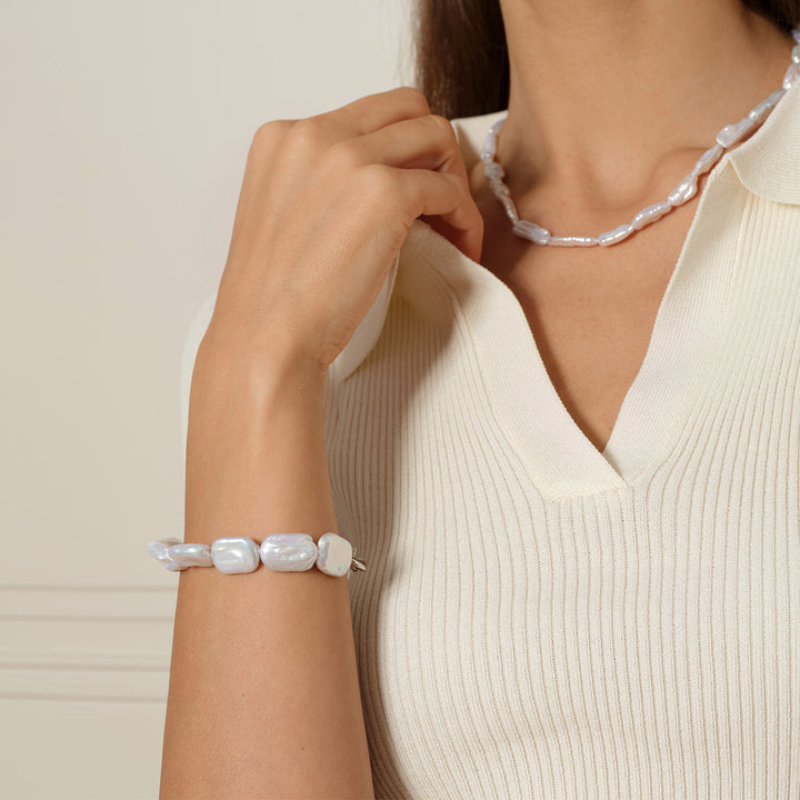 Model wearing squared baroque freshwater pearl bracelet with matching pearl necklace