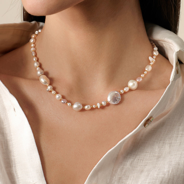 Close-up of baroque mixed freshwater pearl necklace worn on neck, front view