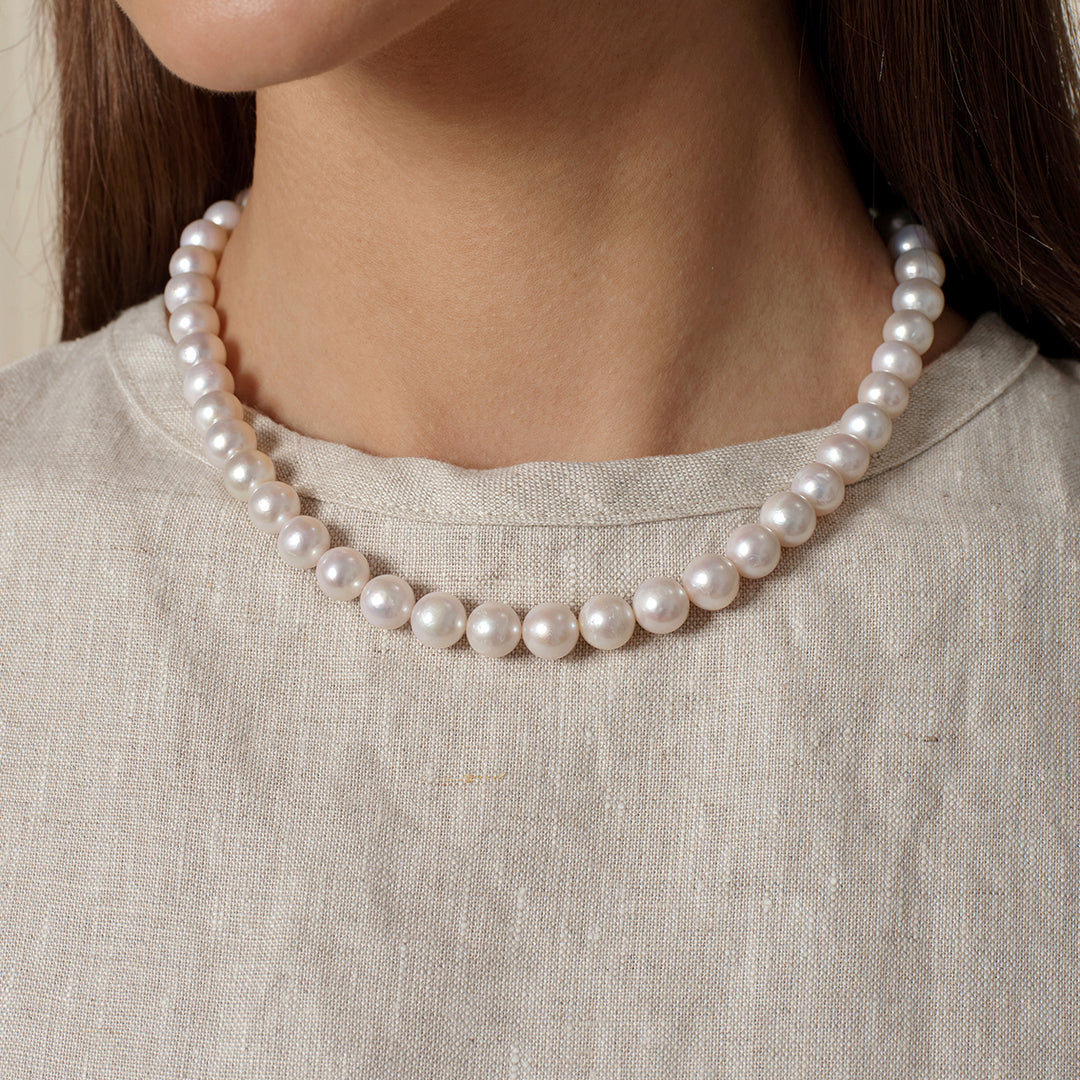 Front on-body view of freshwater pearl strand necklace in 925 sterling silver at neckline