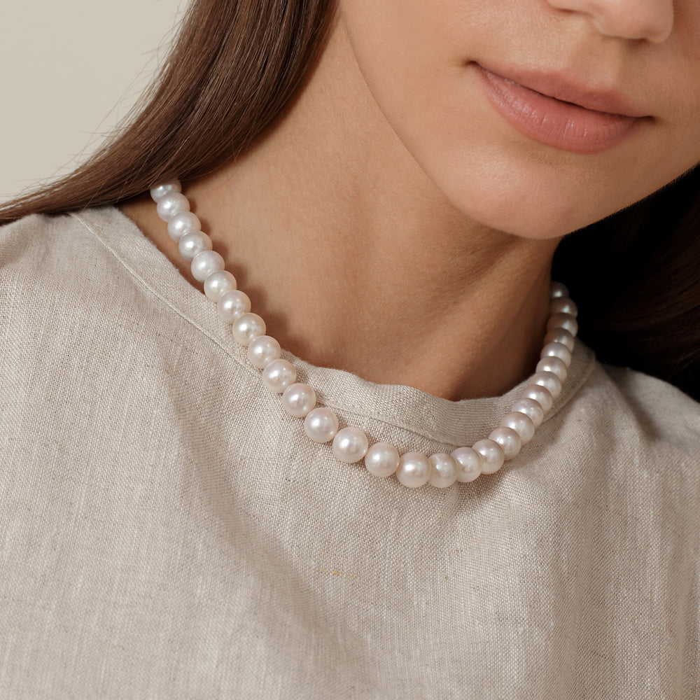 Model wearing round freshwater pearl strand necklace in 925 sterling silver, side on-body view