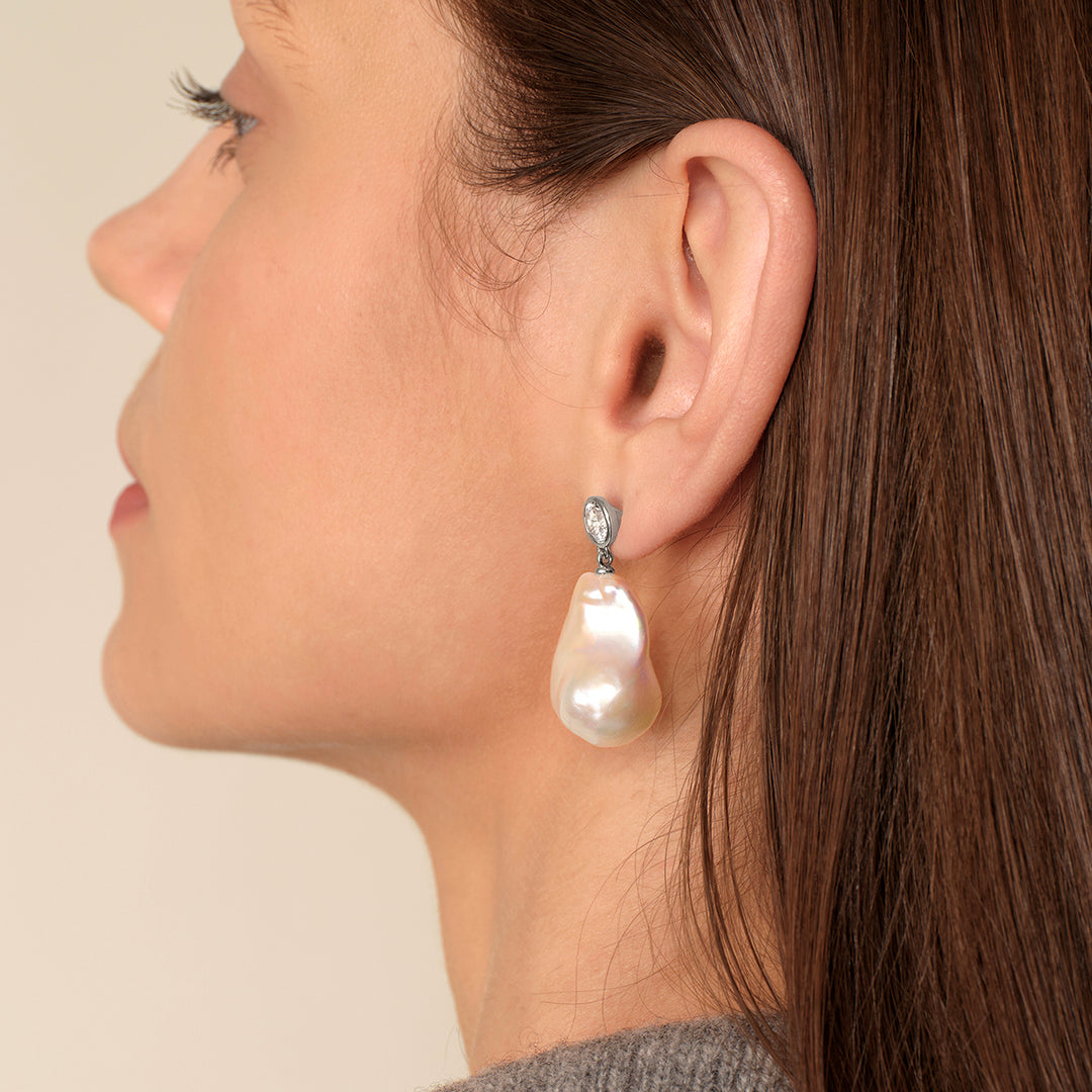 Model in grey knit showing full drop length of baroque freshwater pearl cubic zirconia earring in 925 sterling silver