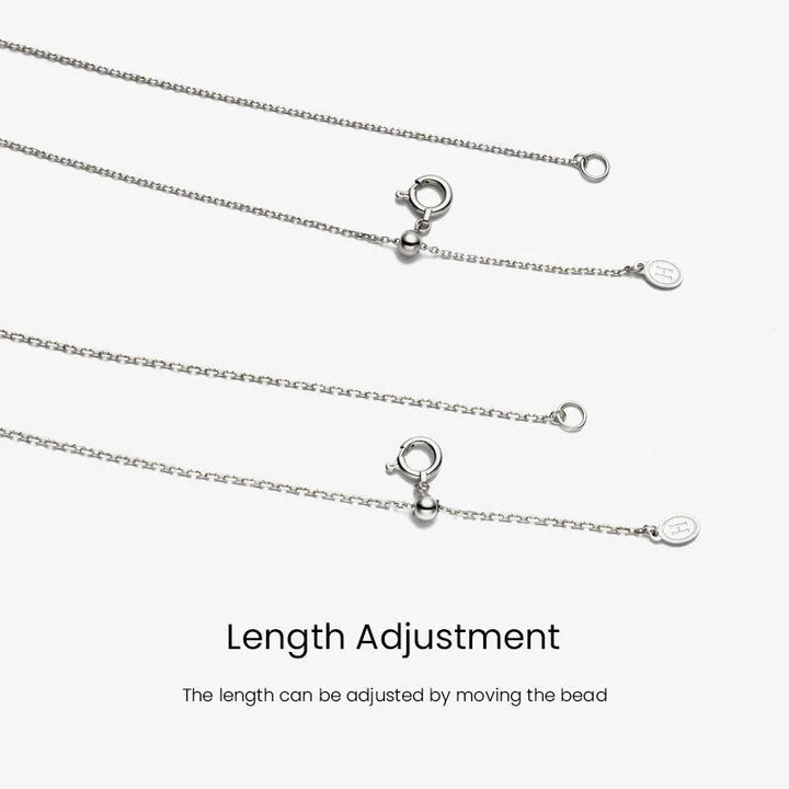 Sterling silver cross chain length adjustment bead and H logo tag detail, adjustable necklace