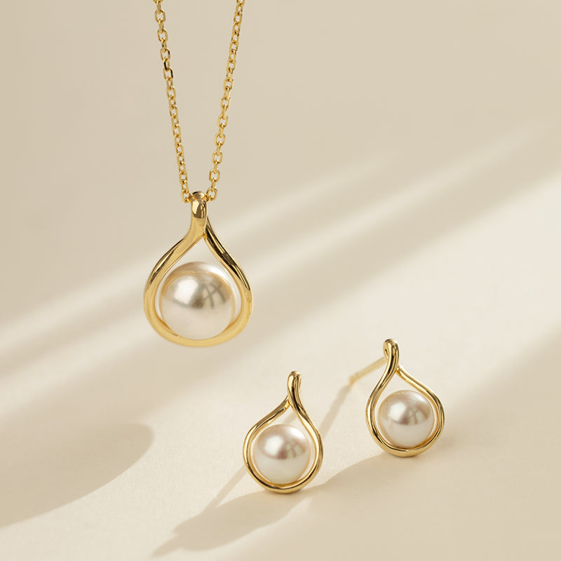 Freshwater pearl gold vermeil teardrop pendant necklace and matching earrings set, styled flat lay