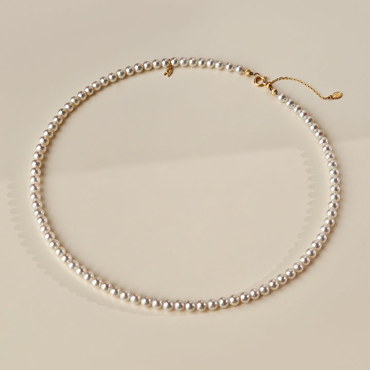 Aurora freshwater pearl gold vermeil strand necklace laid flat showing spring ring clasp and adjustable extender chain, 925 sterling silver