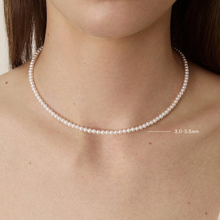 Model wearing Aurora freshwater pearl strand necklace in 925 sterling silver gold vermeil, pearl size 3.0-3.5mm shown on neck
