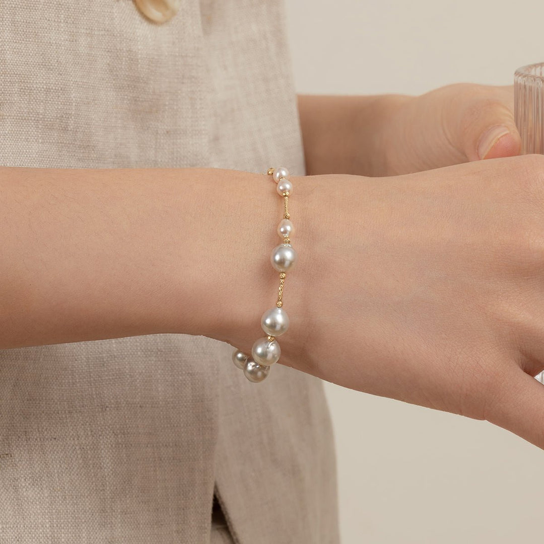 Woman wearing a gold vermeil baroque freshwater pearl bracelet on her wrist