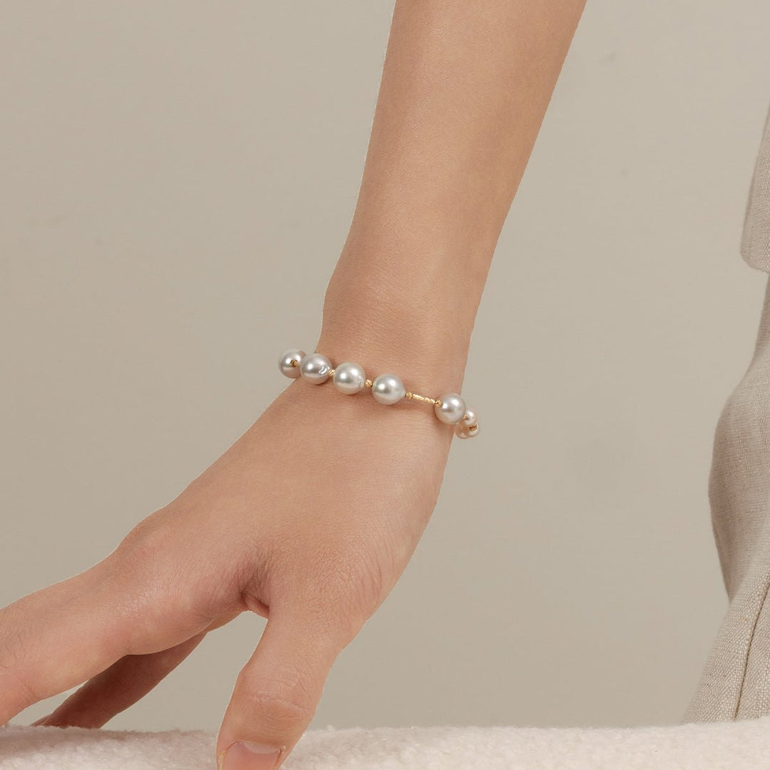 Woman wearing a gold vermeil baroque pearl bracelet, relaxed wrist pose