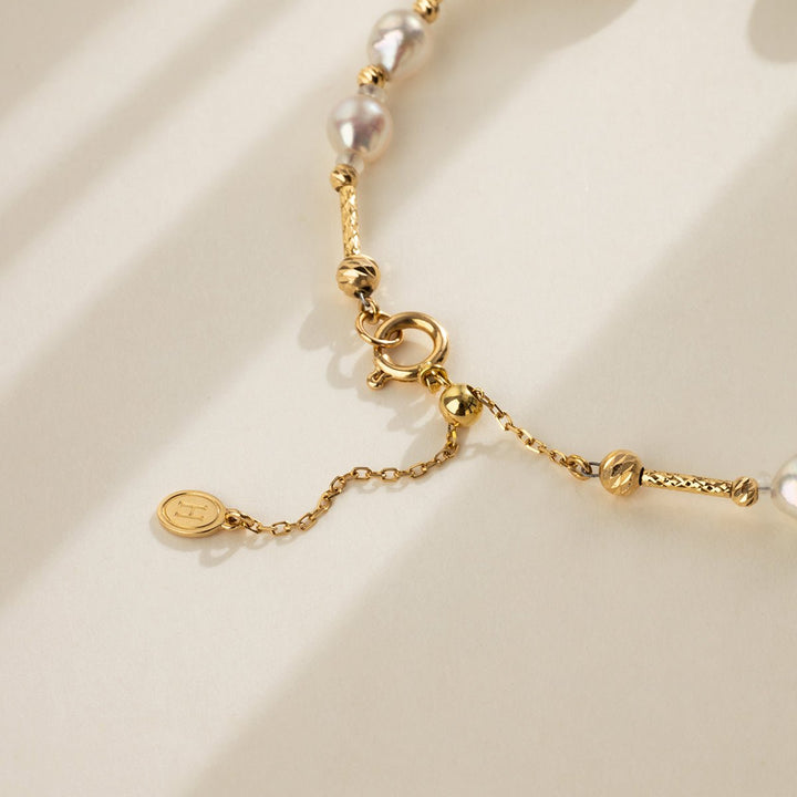 Close-up of spring ring clasp and extender chain on gold vermeil baroque pearl bracelet