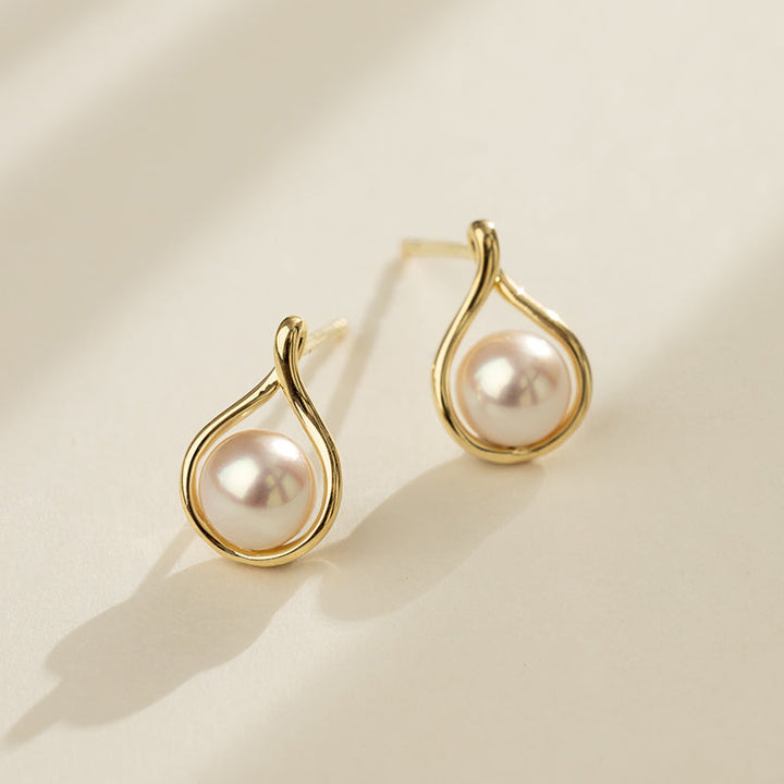Close-up detail of AAAAA freshwater pearl gold vermeil teardrop stud earrings showing post and setting, 925 sterling silver