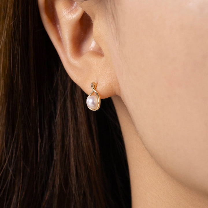Side view of model wearing freshwater pearl gold vermeil teardrop stud earring in 925 sterling silver