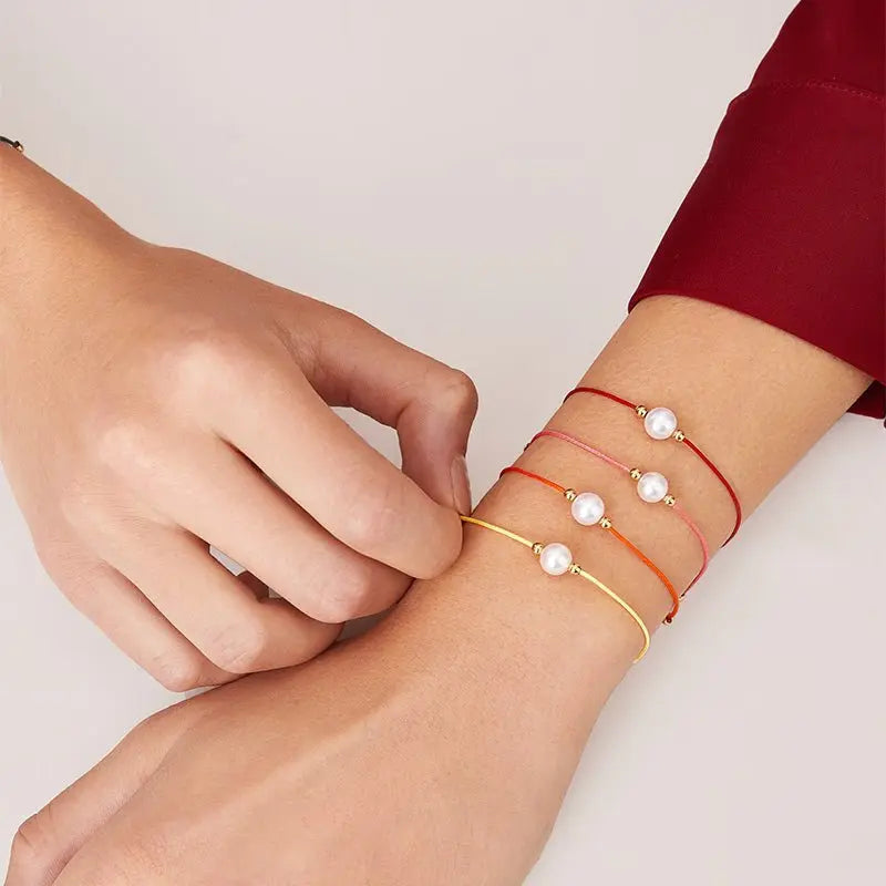 Akoya saltwater pearl 18K gold string bracelet from Exclusive Collection featuring lustrous pearls on a delicate gold chain.