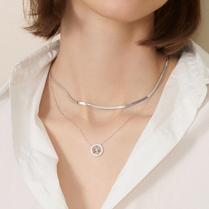 18K solid gold herringbone necklace from Fine Line Collection, showcasing sleek, woven chain design on a neutral background.