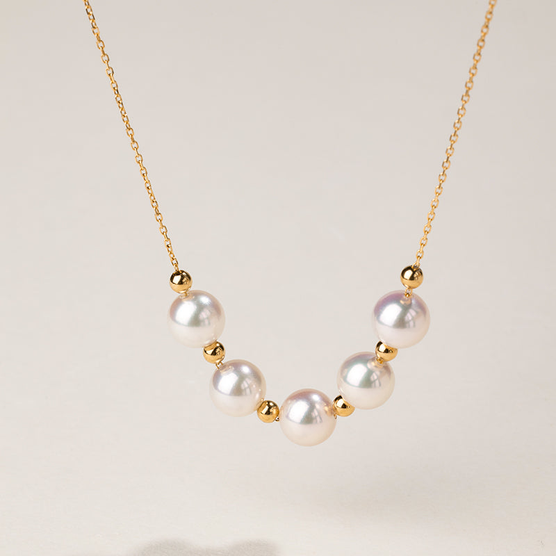 Akoya 18k yellow gold baby's breath smile necklace from Fine Line Collection, featuring delicate gold chain and tiny floral accents.