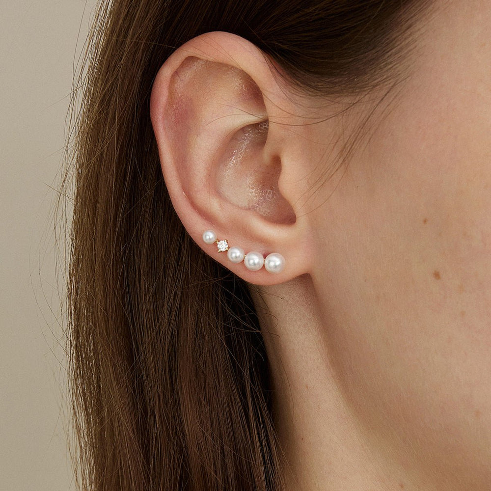 Model wearing freshwater pearl gold vermeil sudden spark ear climber earring, close-up side view