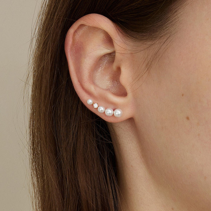 Model wearing freshwater pearl gold vermeil sudden spark ear climber earring, close-up side view