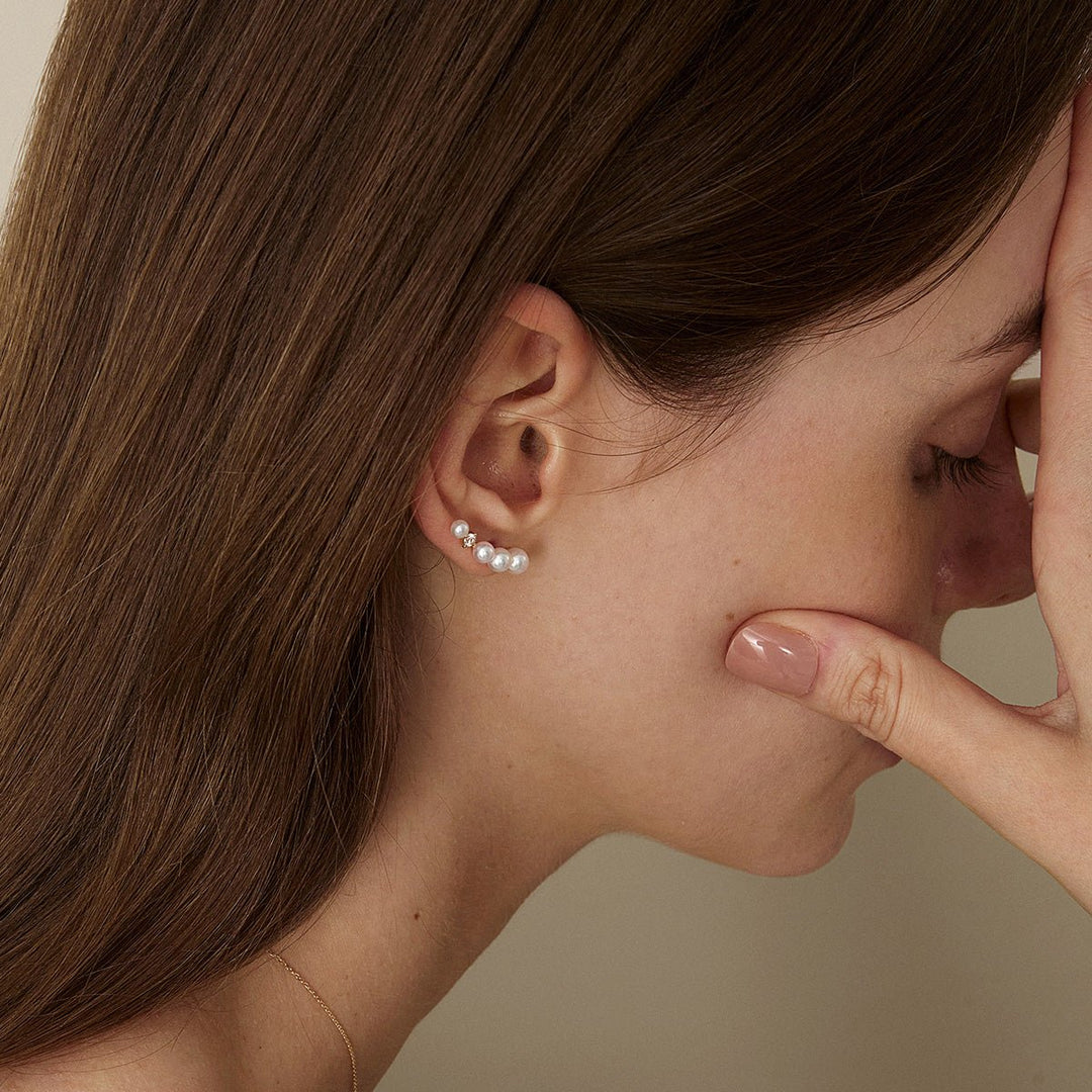 Model wearing freshwater pearl gold vermeil sudden spark ear climber earring, side close-up downward view