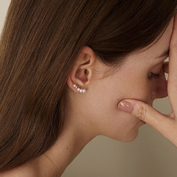 Model wearing freshwater pearl gold vermeil sudden spark ear climber earring, side close-up downward view