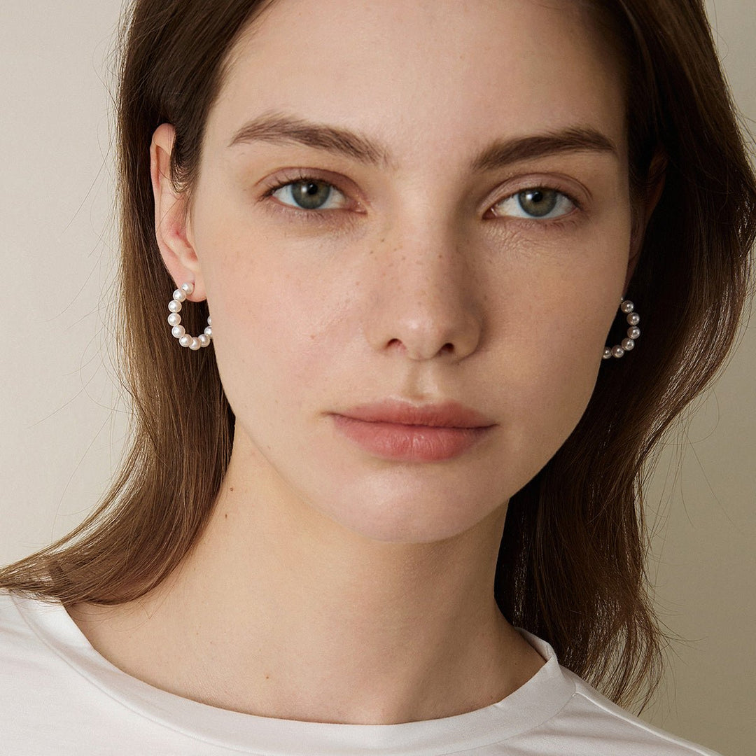 Woman wearing gold vermeil freshwater pearl circle earrings, side profile