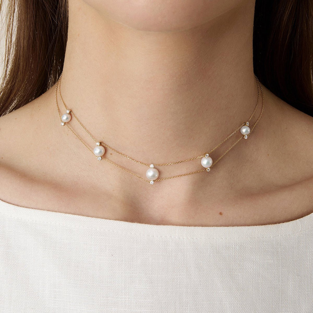 Model wearing freshwater pearl lab-grown diamond gold vermeil double strand necklace with white top
