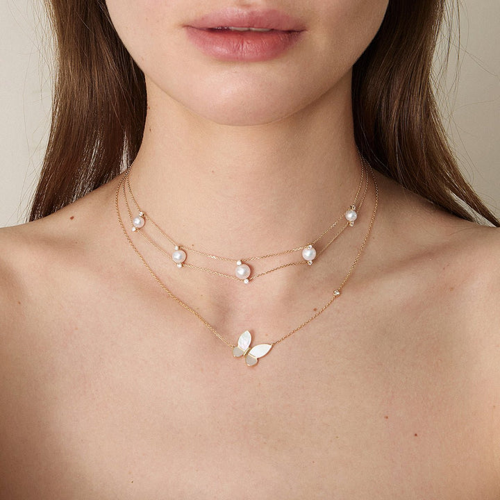 Layered styling of freshwater pearl gold vermeil double strand necklace with mother-of-pearl butterfly necklace