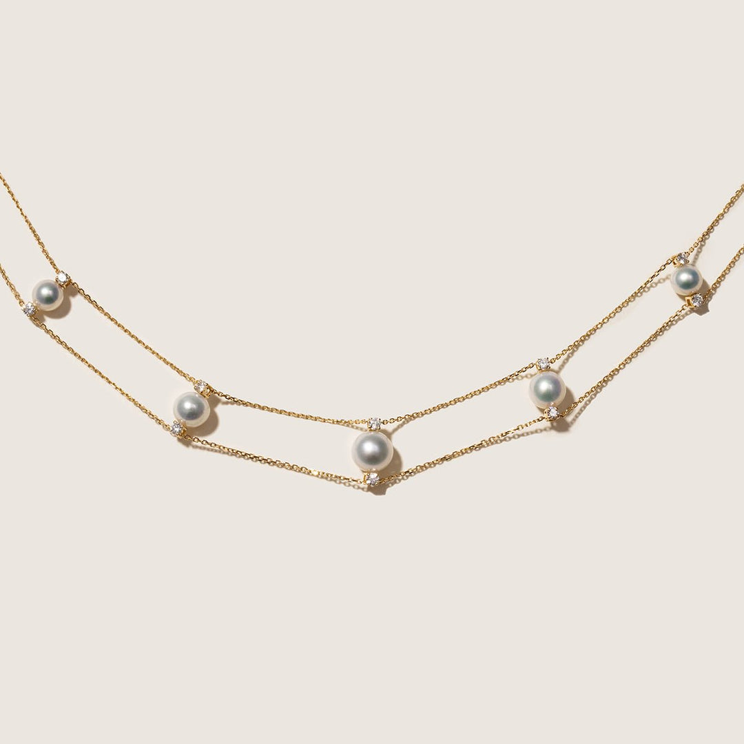 Flat lay of AAAAA freshwater pearl and lab-grown diamond gold vermeil double strand necklace