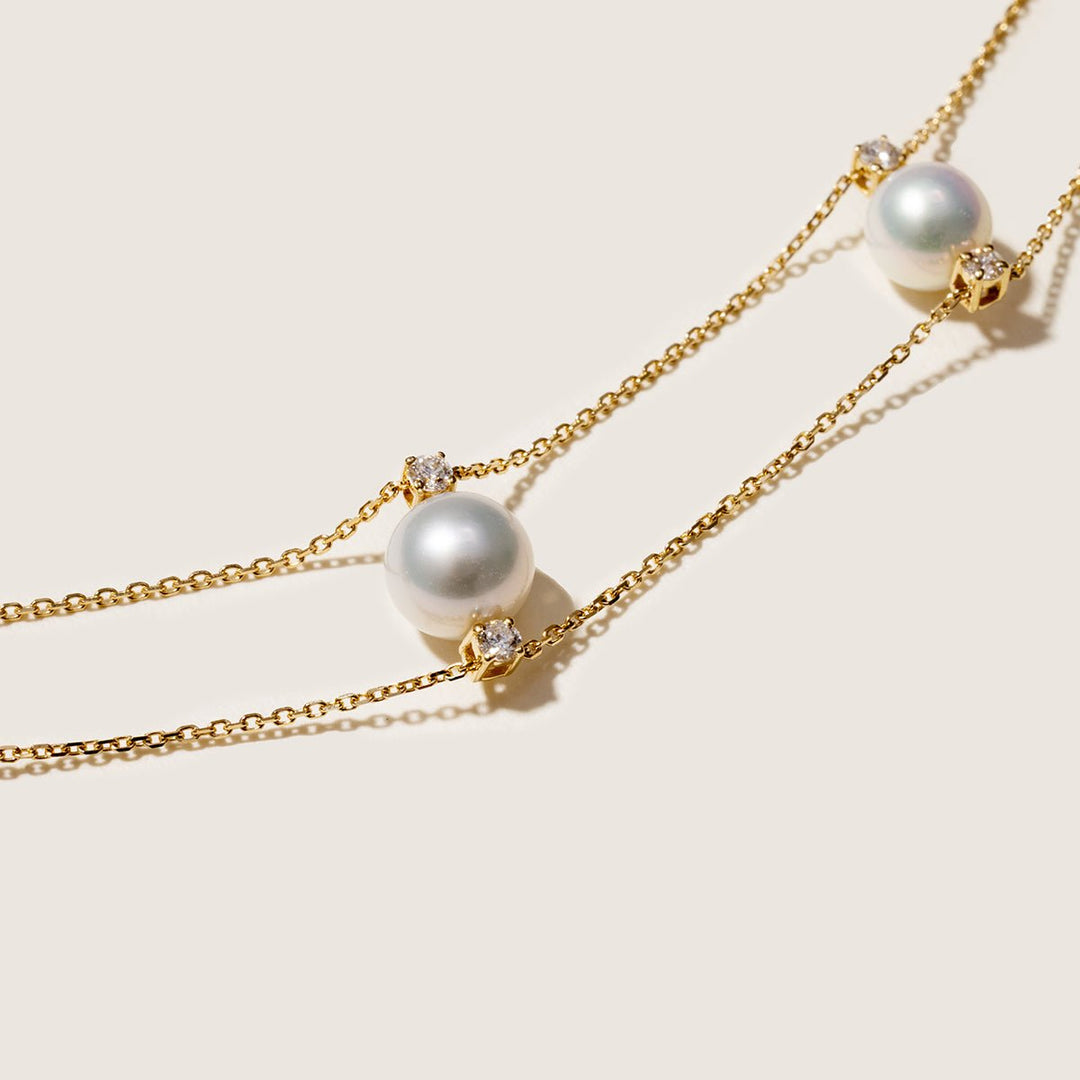 Detail shot of graduating freshwater pearls and lab-grown diamonds on gold vermeil double strand necklace