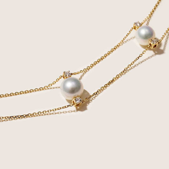 Detail shot of graduating freshwater pearls and lab-grown diamonds on gold vermeil double strand necklace
