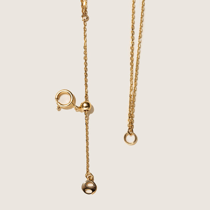 Gold vermeil spring ring clasp with adjustable bead and round logo tag detail, 925 sterling silver chain