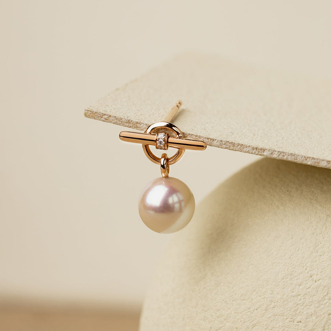 Close-up of rose gold vermeil parallel clasp with lab-grown diamond detail, freshwater pearl drop earring