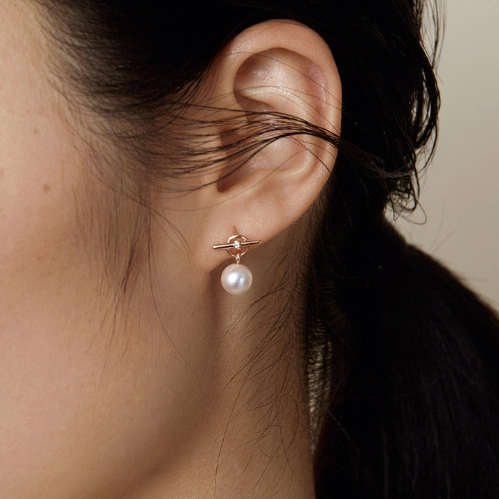 Model wearing freshwater pearl rose gold vermeil parallel clasp drop earring, side-back close-up