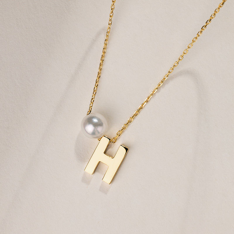 Akoya saltwater pearl necklace with 18K gold hanging initials, featuring a delicate design and custom personalization.