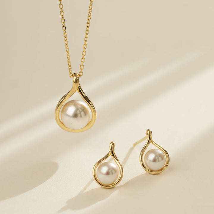 Freshwater pearl gold vermeil teardrop pendant necklace and matching earrings set, styled flat lay