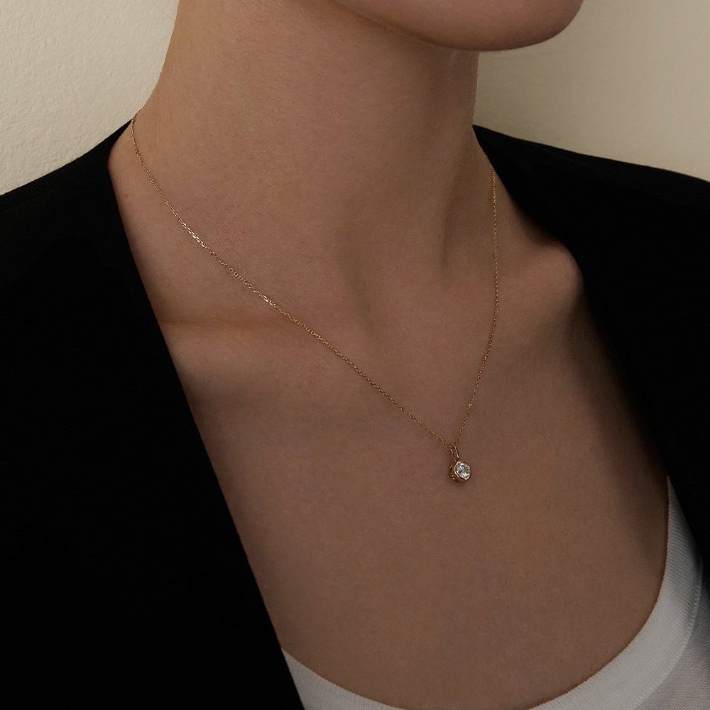 Model wearing lab-grown diamond gold vermeil pendant necklace styled with black blazer