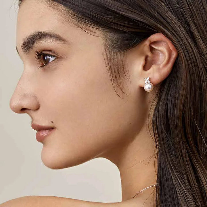 Woman wearing a freshwater pearl and diamond flower stud earring