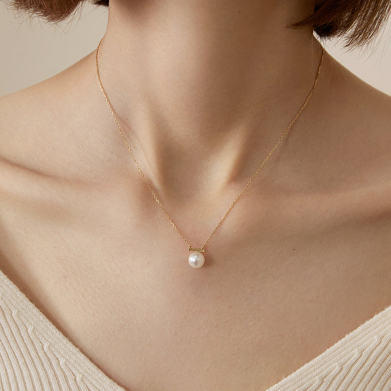 Akoya pearl and 18K gold necklace from Melody Collection, featuring a delicate pearl pendant on a fine gold chain.