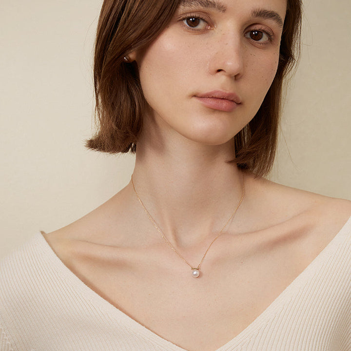 Akoya pearl 18K gold necklace from Melody Collection featuring a delicate whole rest note pendant.
