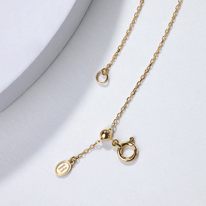 Akoya pearl 18K gold necklace from Melody Collection featuring a whole rest note pendant on a delicate chain.