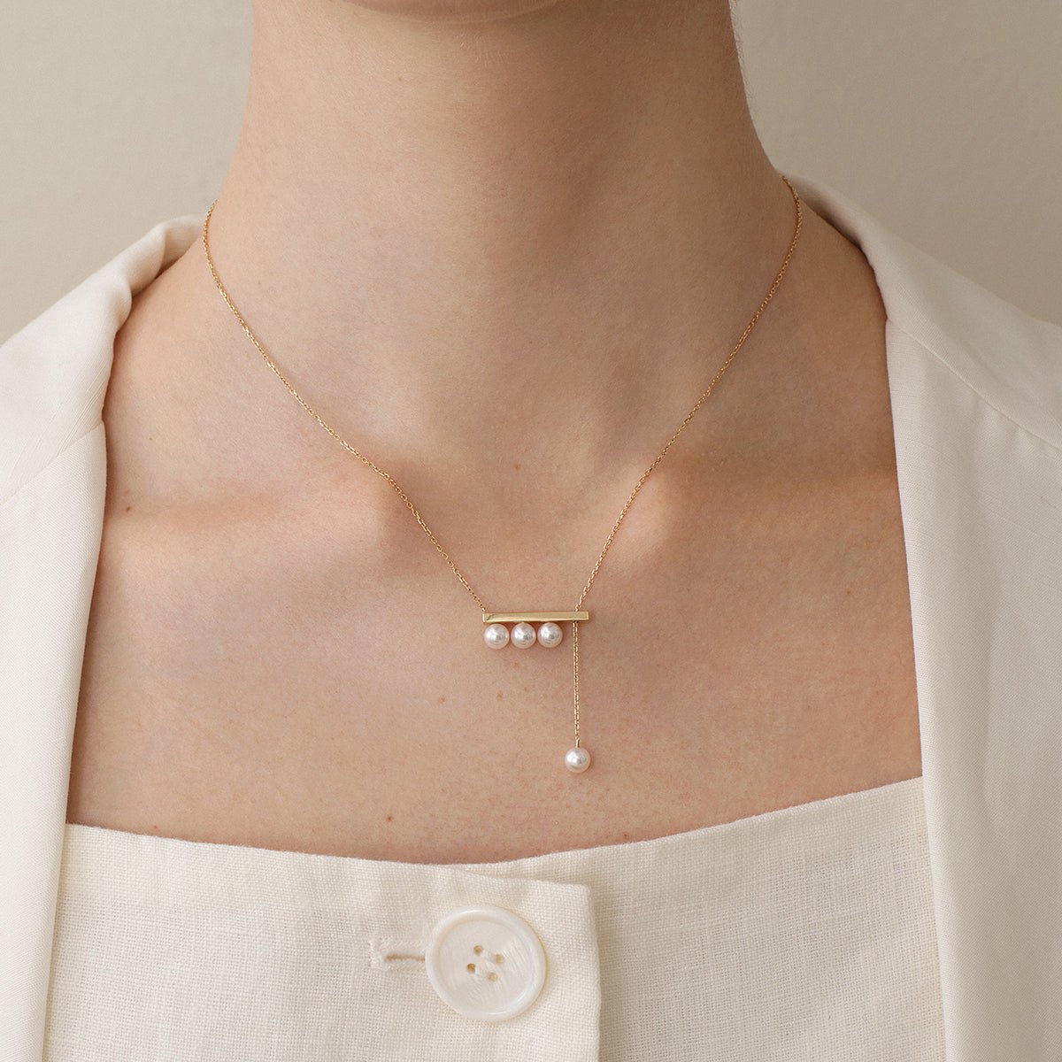 Akoya saltwater pearl 18K yellow gold balance beam necklace from Melody Collection, featuring a elegant pearl pendant on a delicate chain.