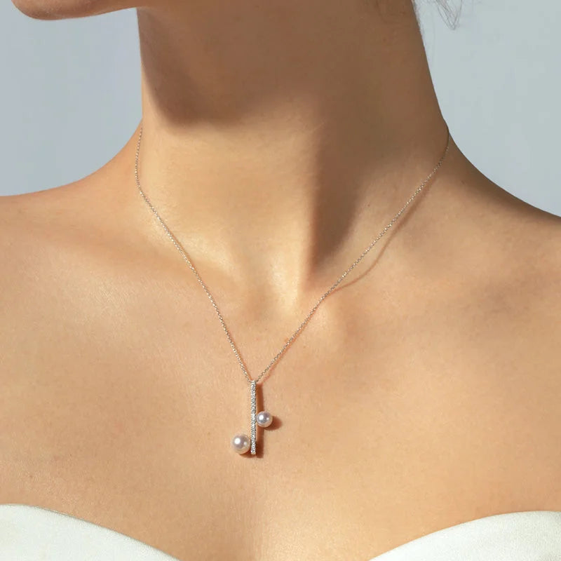 Model wearing freshwater pearl sterling silver note diamond pendant necklace, front view