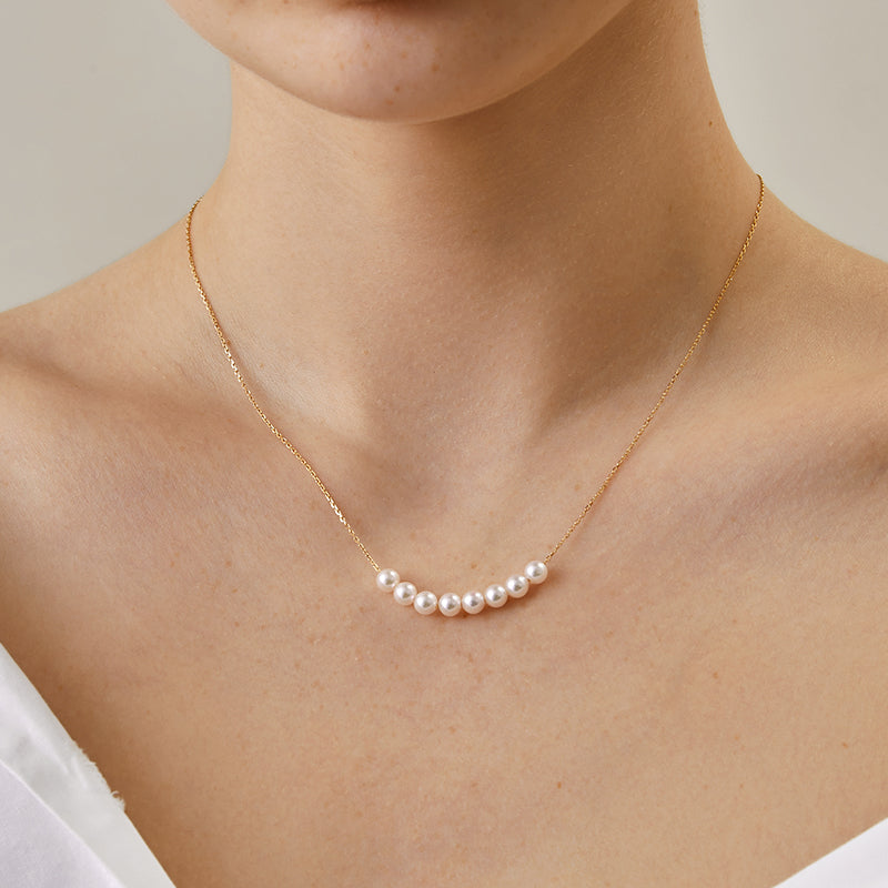 Akoya pearl 18K gold fashion smile necklace from Mermaid's Tear Collection, featuring a delicate pearl pendant on a gold chain.