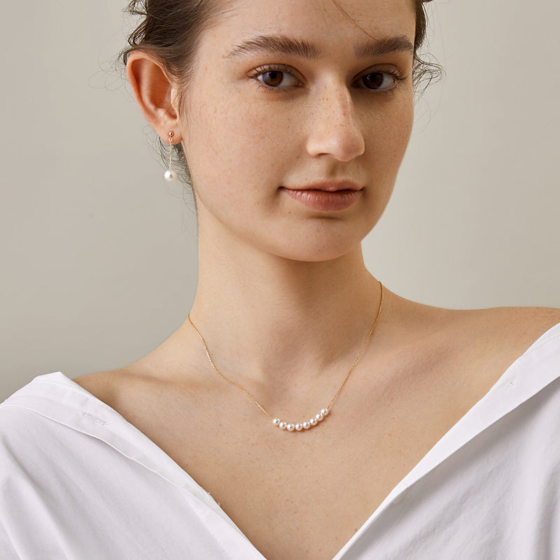 Akoya pearl and 18K gold smile necklace from Mermaid's Tear Collection featuring a delicate pearl pendant on a gold chain