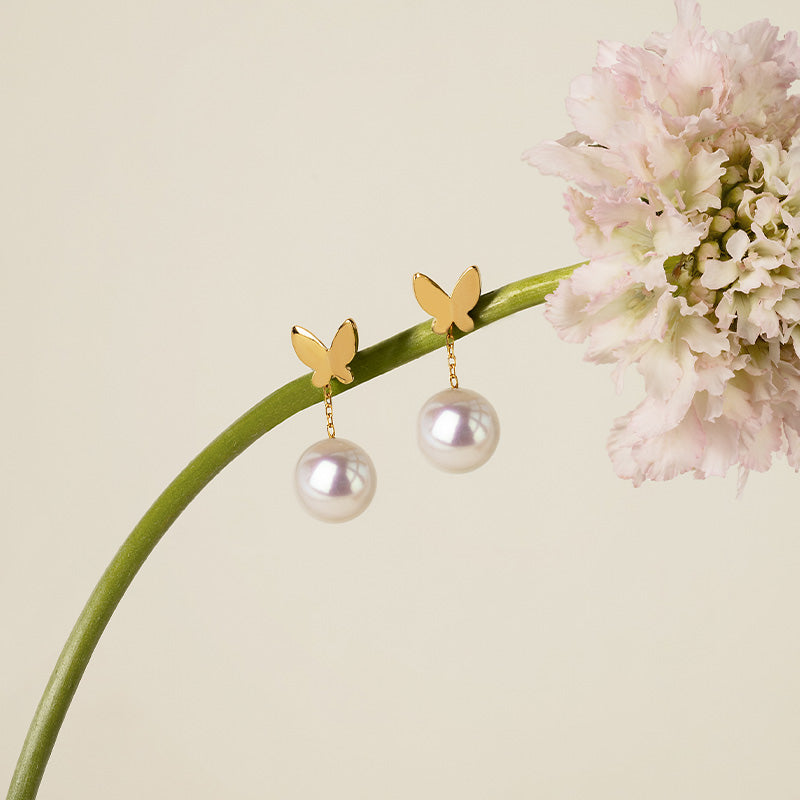 Freshwater pearl gold vermeil butterfly drop earrings hanging on botanical stem with pink flower, 925 sterling silver