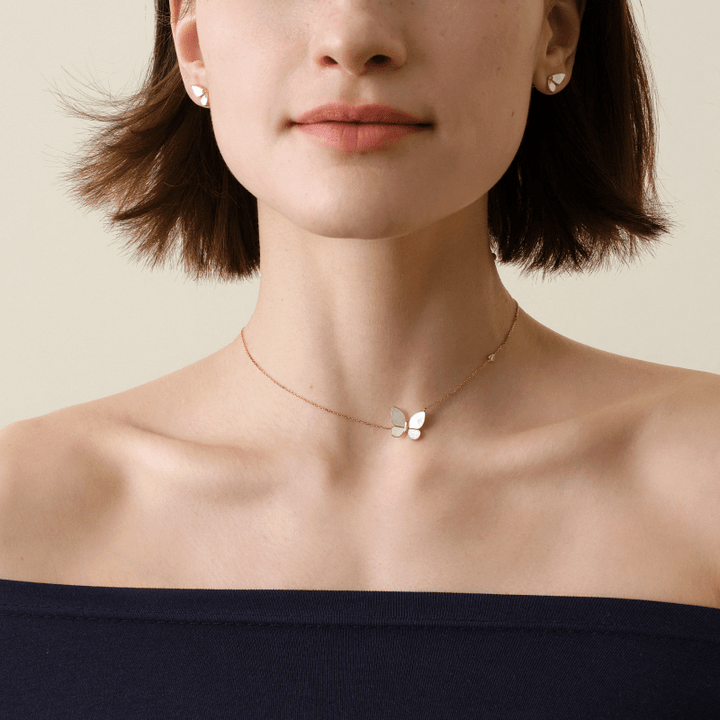Woman wearing a gold vermeil mother-of-pearl butterfly pendant necklace