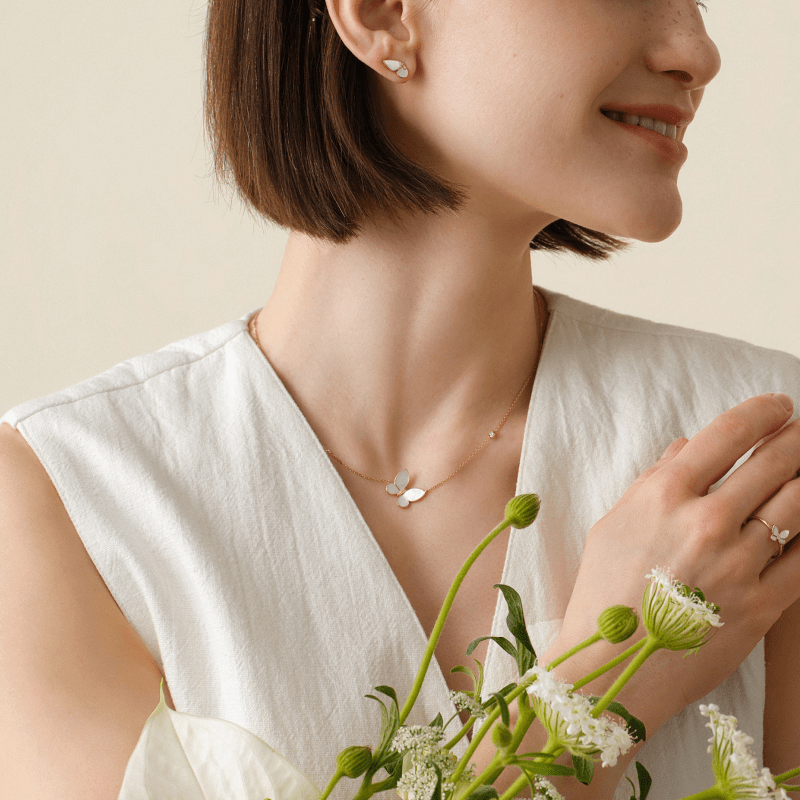 Sterling silver butterfly necklace shown on neck with open collar