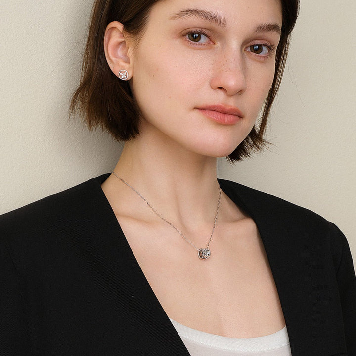 Portrait of model wearing lab-grown diamond butterfly pendant necklace with black blazer