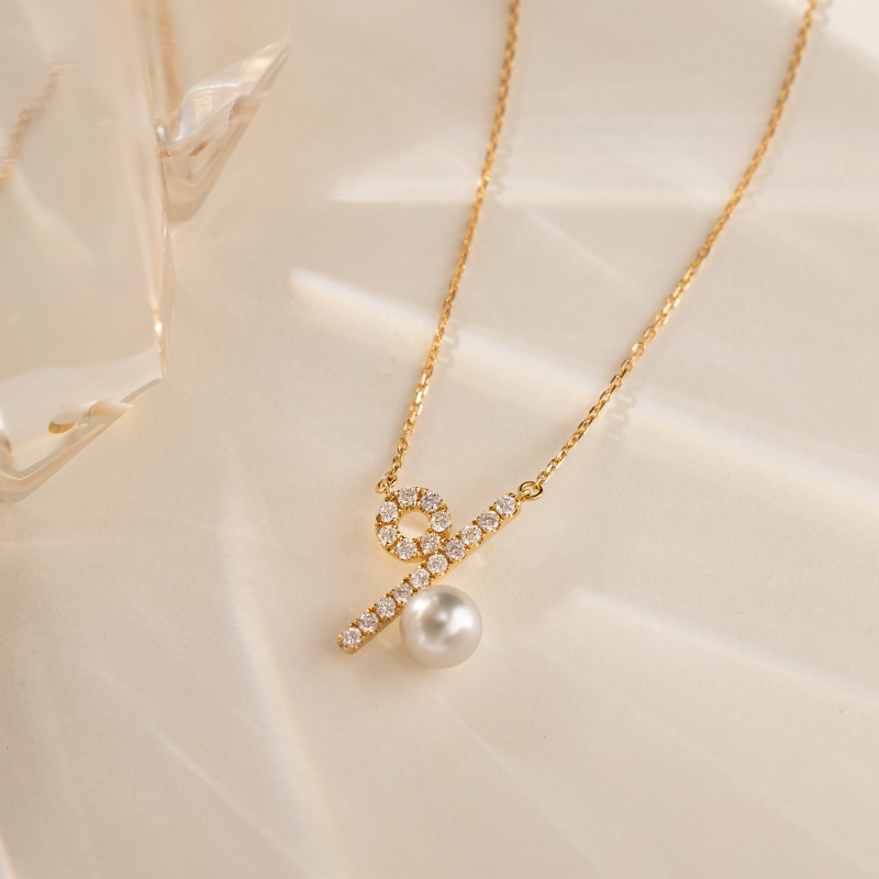 Akoya saltwater pearl and diamond necklace in 10K/18K yellow gold from Percent Collection, featuring a delicate chain and elegant pendant.