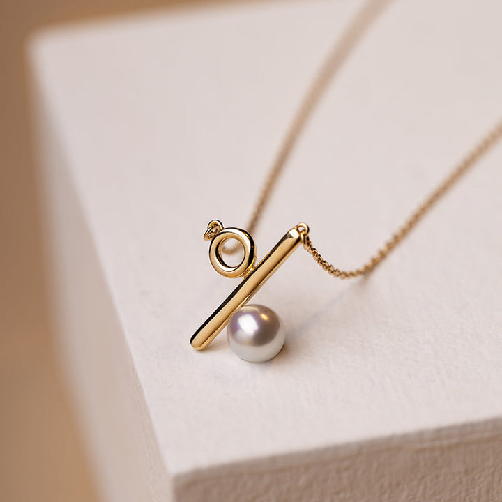 Akoya pearl 18K gold necklace from Percent Collection featuring a delicate design and lustrous white pearls.