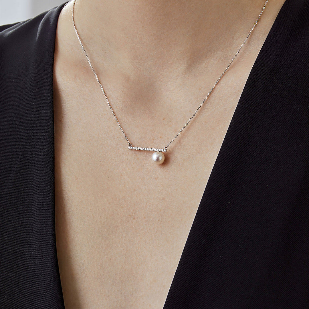 Akoya pearl 18K white gold moon-shaped diamond necklace from Reflection Collection, featuring a lustrous pearl and sparkling diamonds.