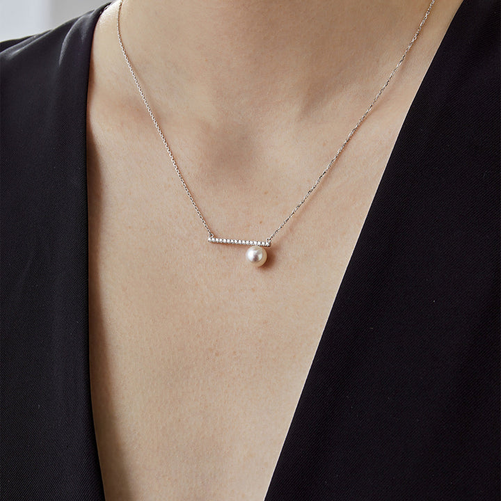 Akoya pearl 18K white gold moon-shaped diamond necklace from Reflection Collection, featuring a lustrous pearl and sparkling diamonds.