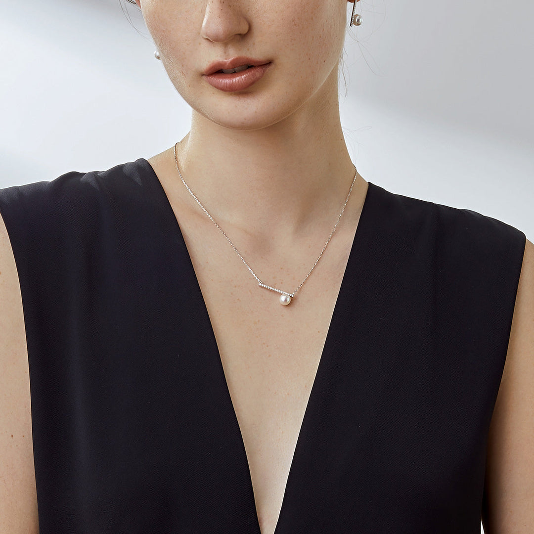 Akoya pearl and moon-shaped diamond necklace in 18K white gold from Reflection Collection, elegant jewelry with a refined design.